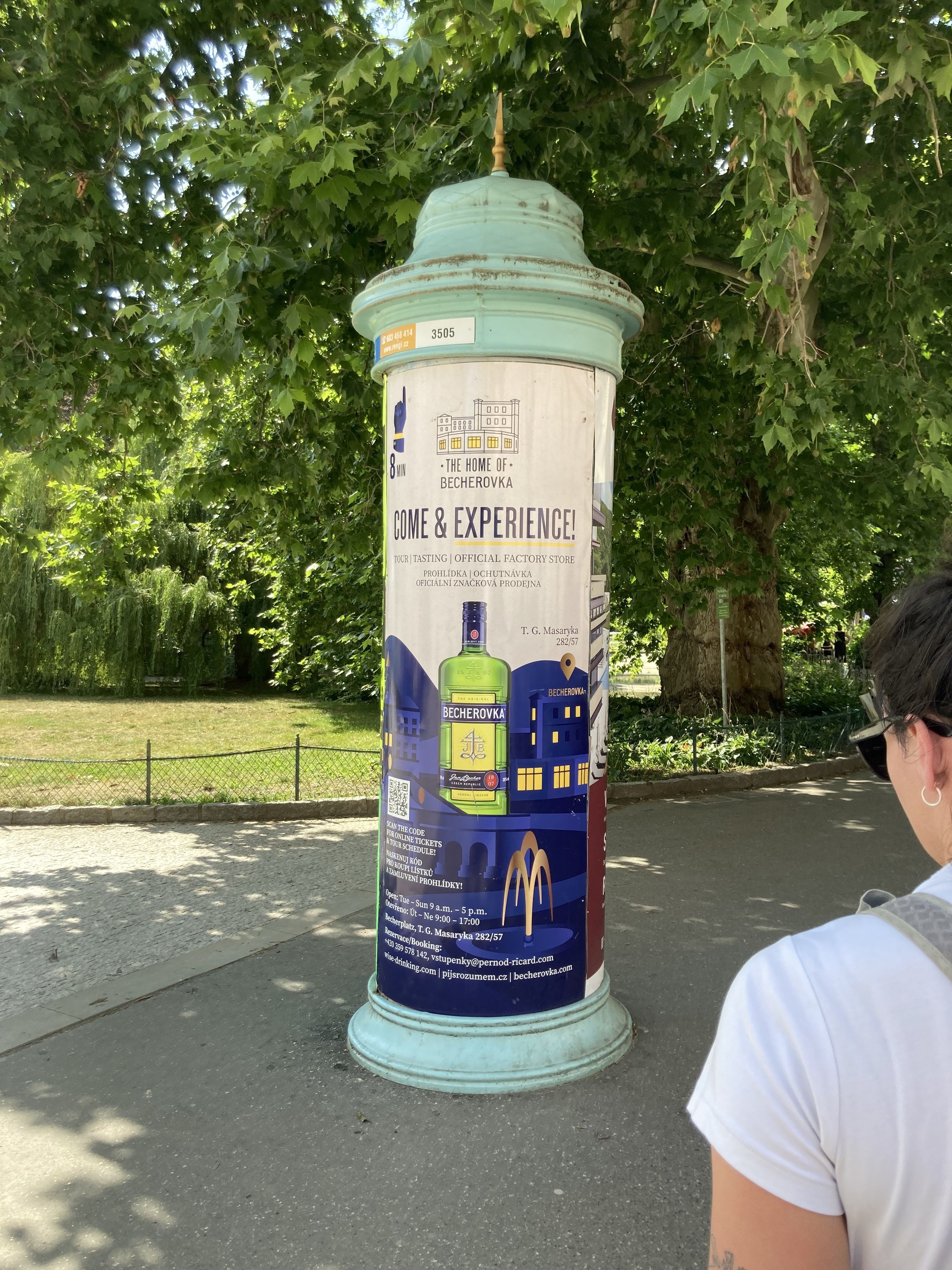 Becherovka advertising in a park in Karlovy Vary, reinforcing the city of origin.