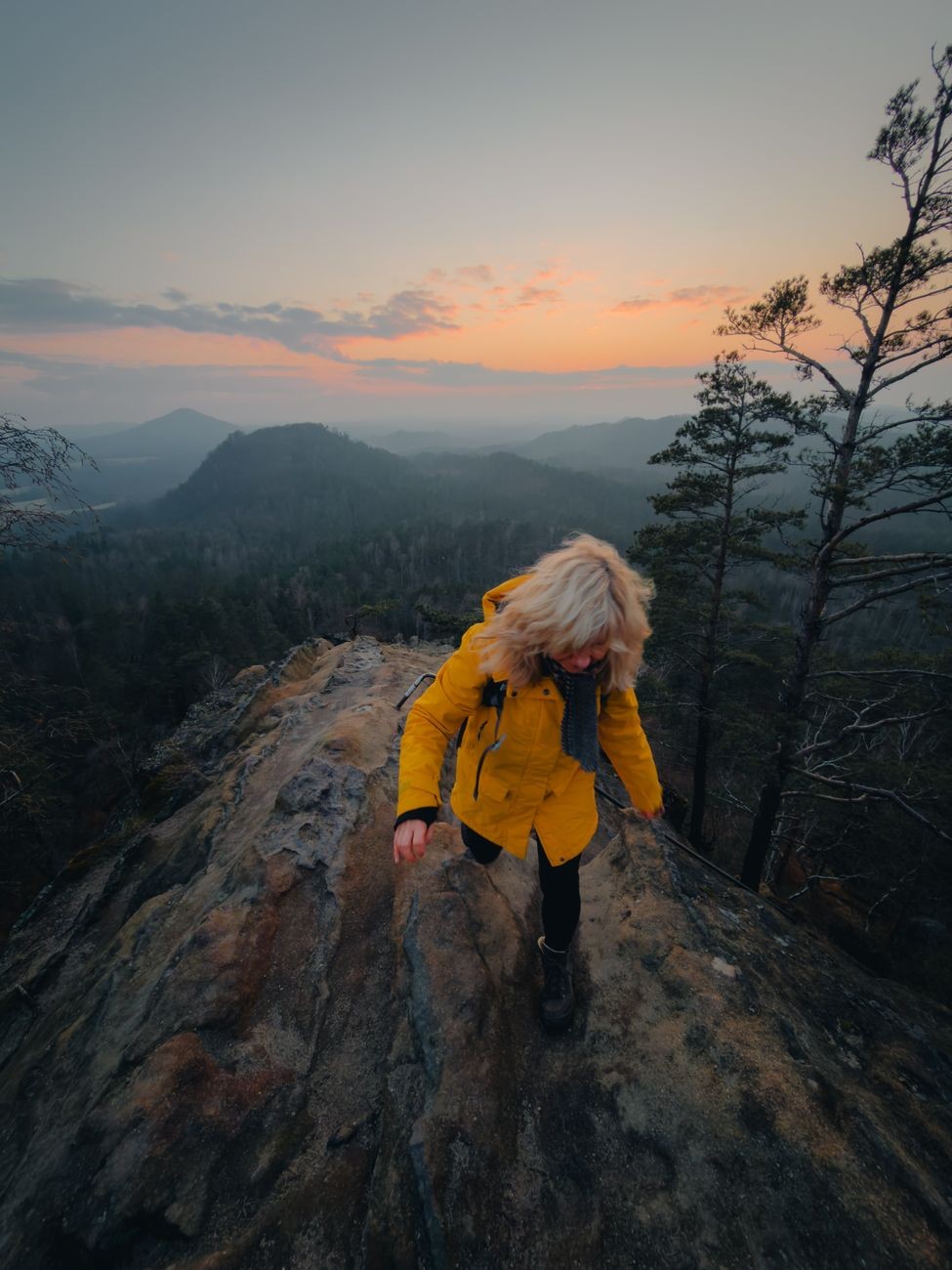 Hiker on dramatic sandstone terrain, conveying the national-park hiking experience.