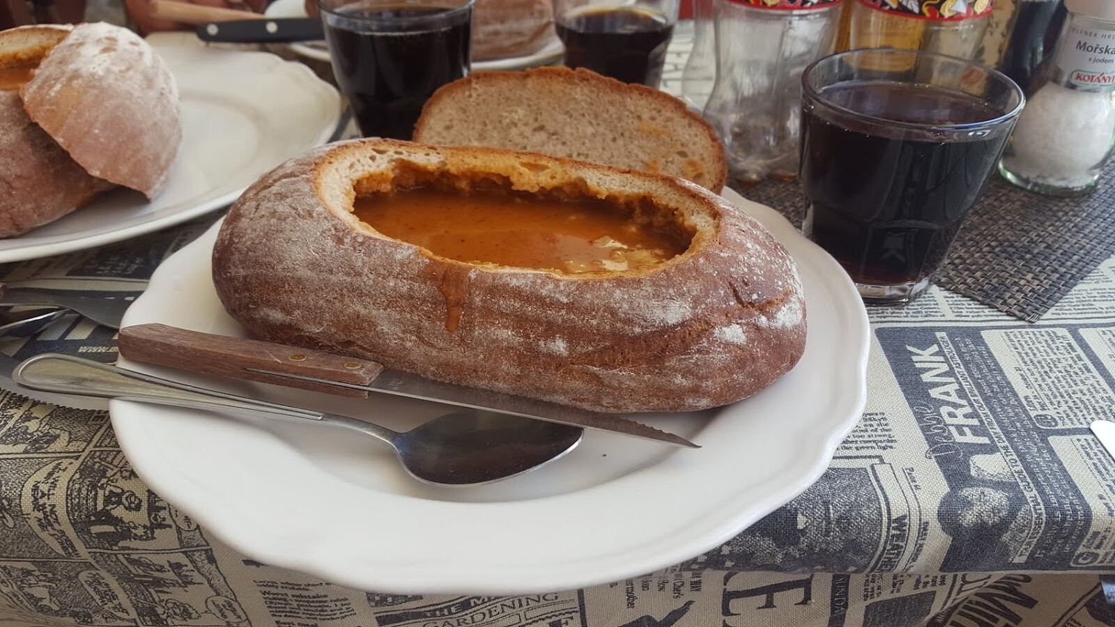 Prague goulash served in bread, illustrating a thick Czech restaurant presentation.