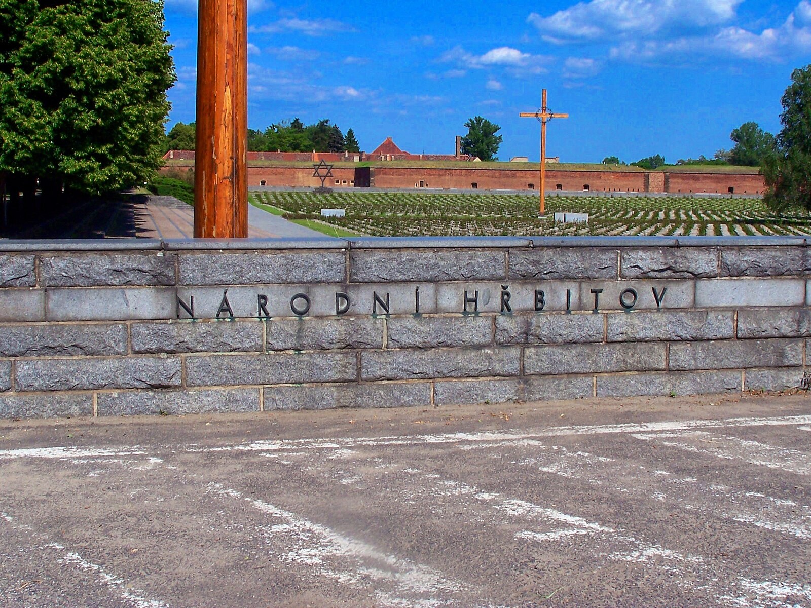 National Cemetery and Small Fortress area at Terezín, including memorial religious symbols and fortress walls.