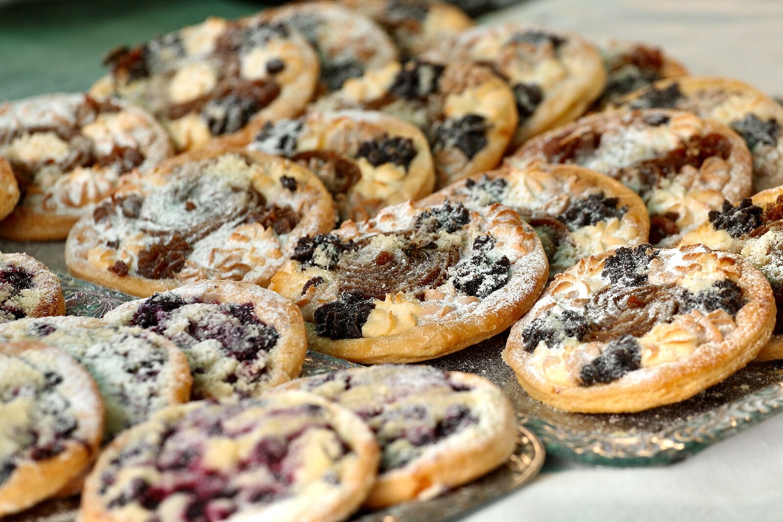 A group of traditional Czech koláče with visibly varied fillings and appearances.