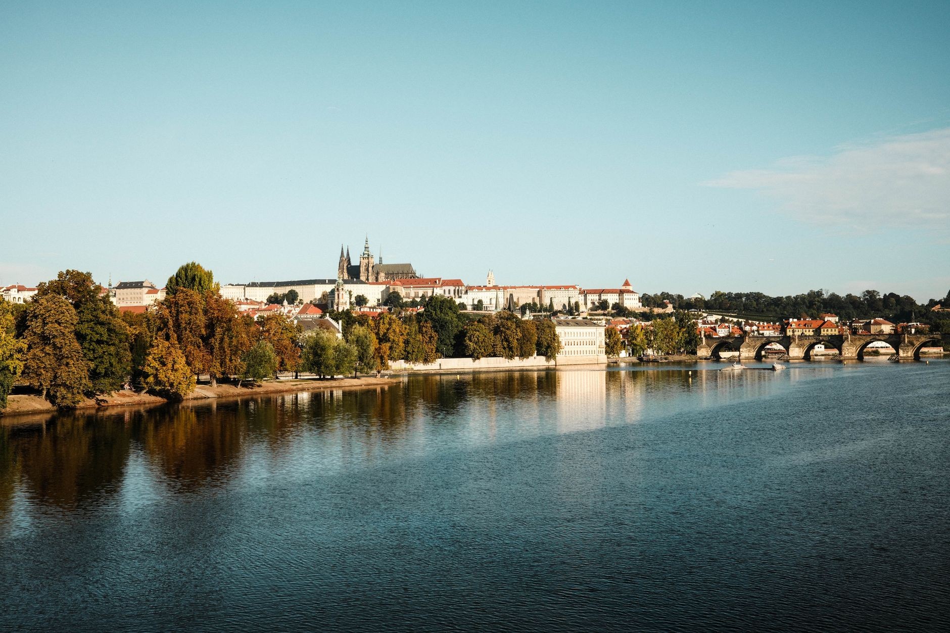 Broad Prague panorama showing the Castle, Vltava and central-city landmarks in one frame.