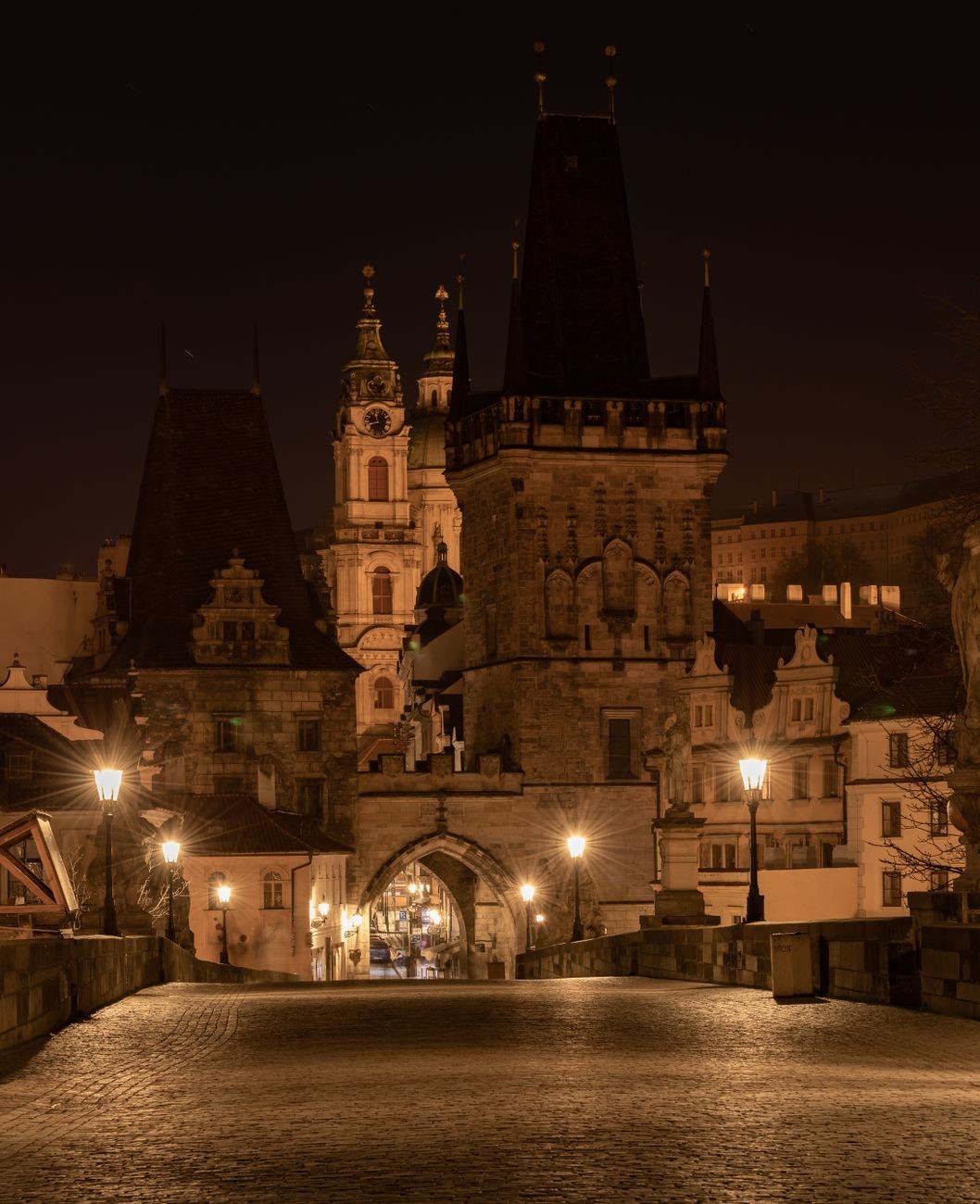 Night view of Charles Bridge and surrounding historic architecture.