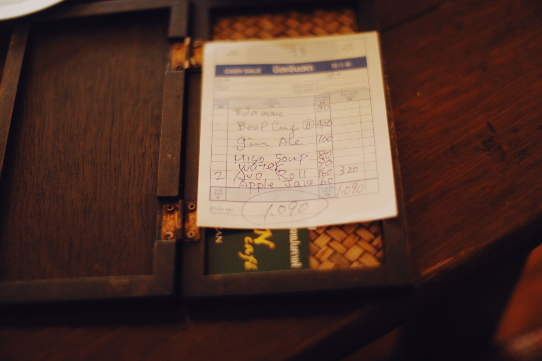 Close-up of a restaurant bill on a table.