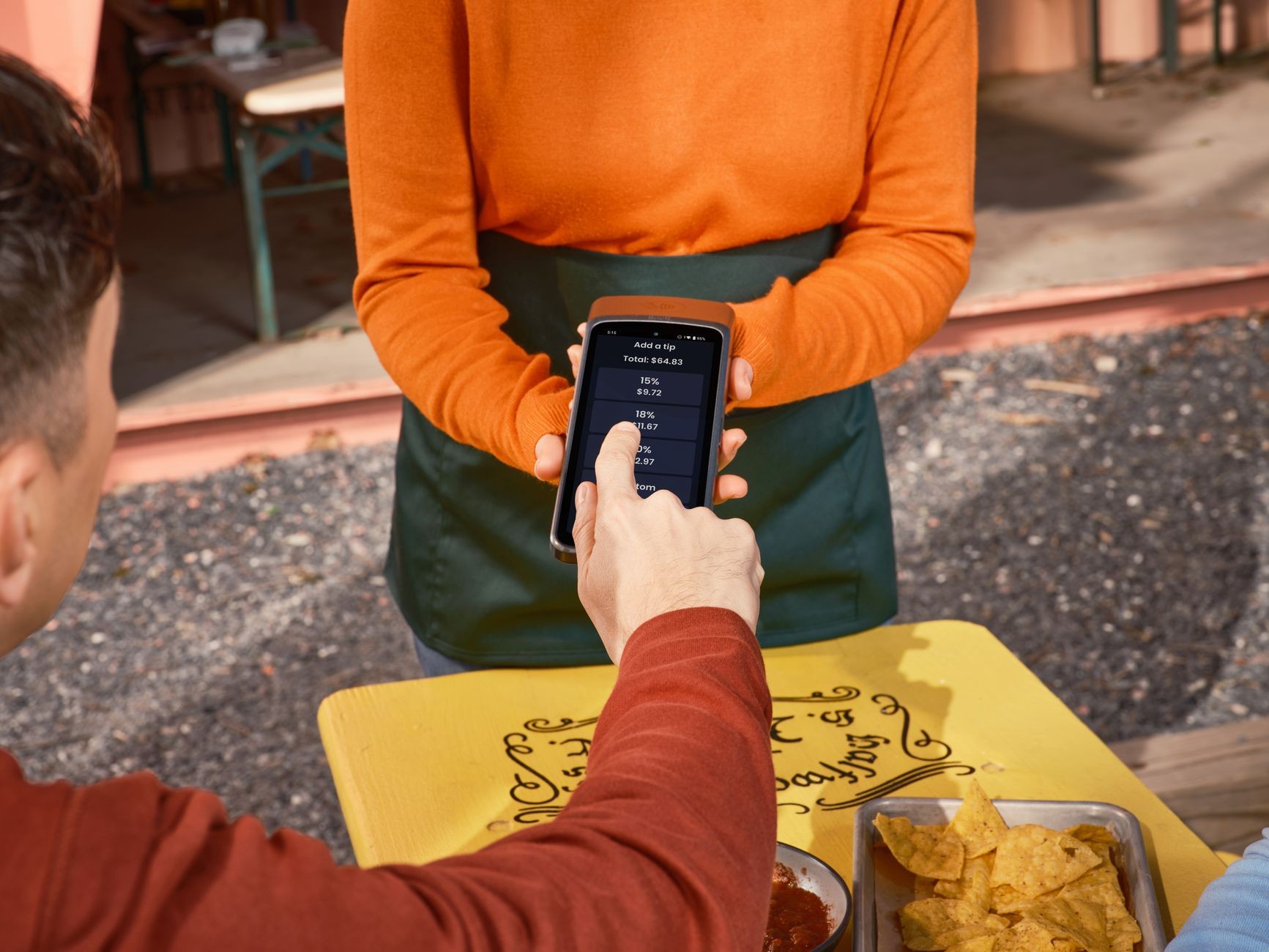 Phone/POS screen being used for payment/tipping at an outdoor restaurant.