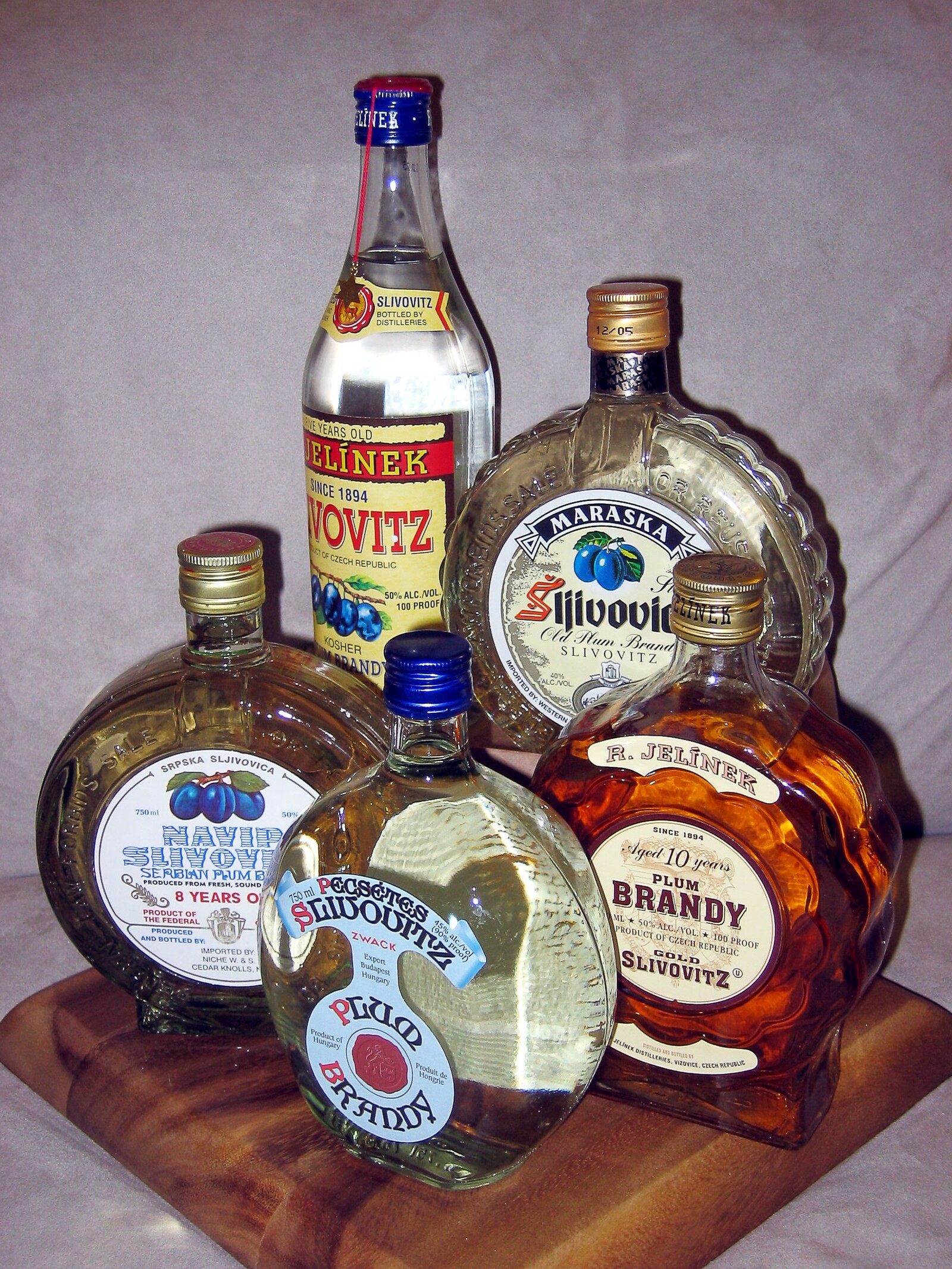 Several slivovitz bottles together, illustrating variation in producers/styles.