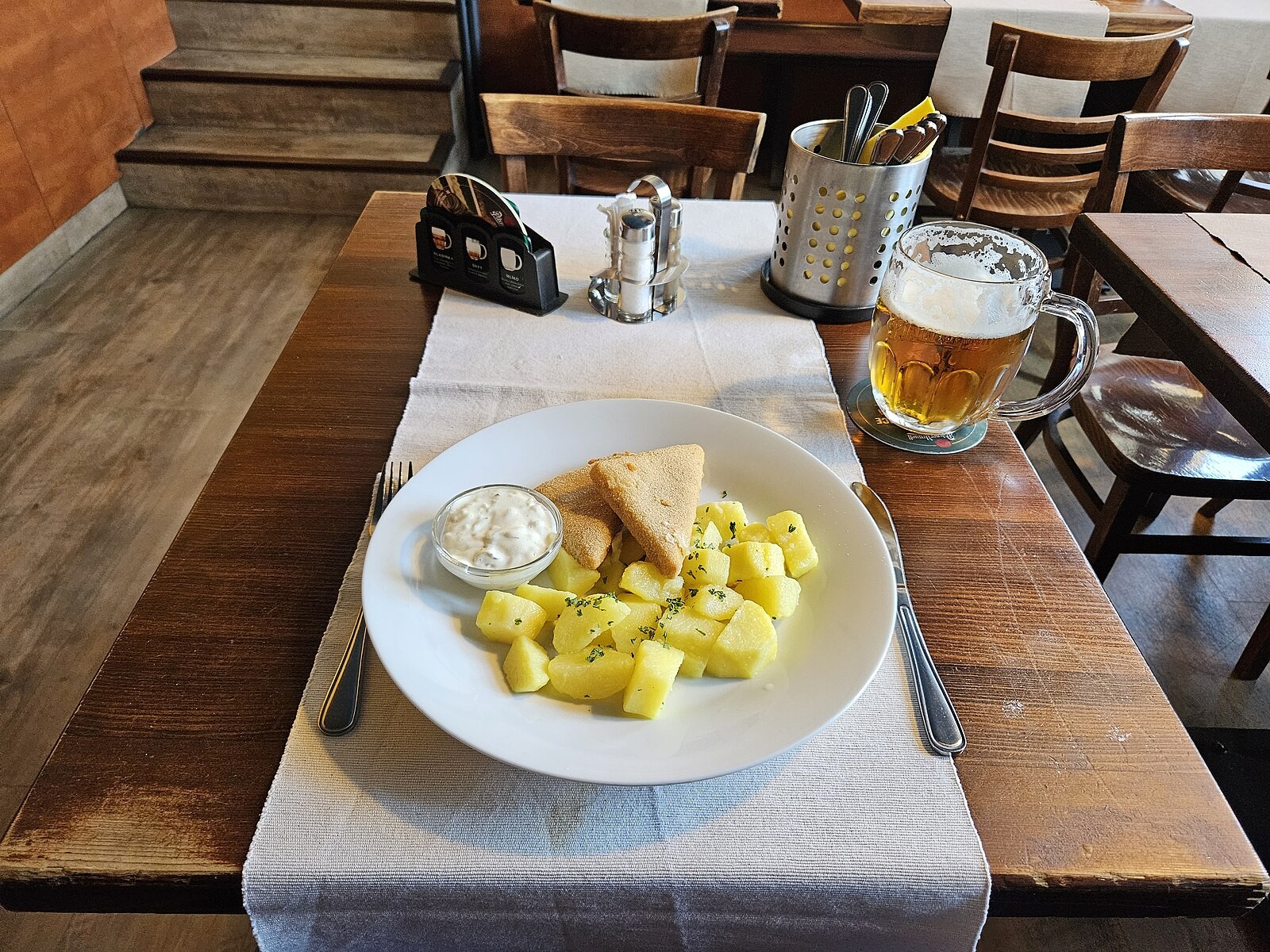 Czech fried cheese plated with common accompaniments.