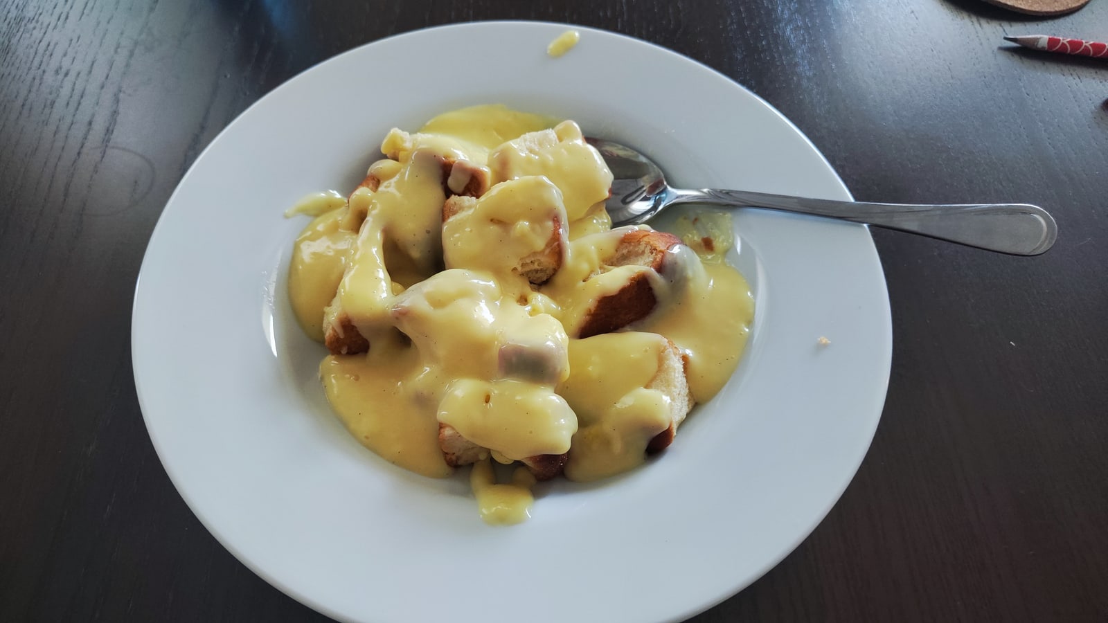 A second exact serving of Czech buchtičky with sauce, materially different plating.