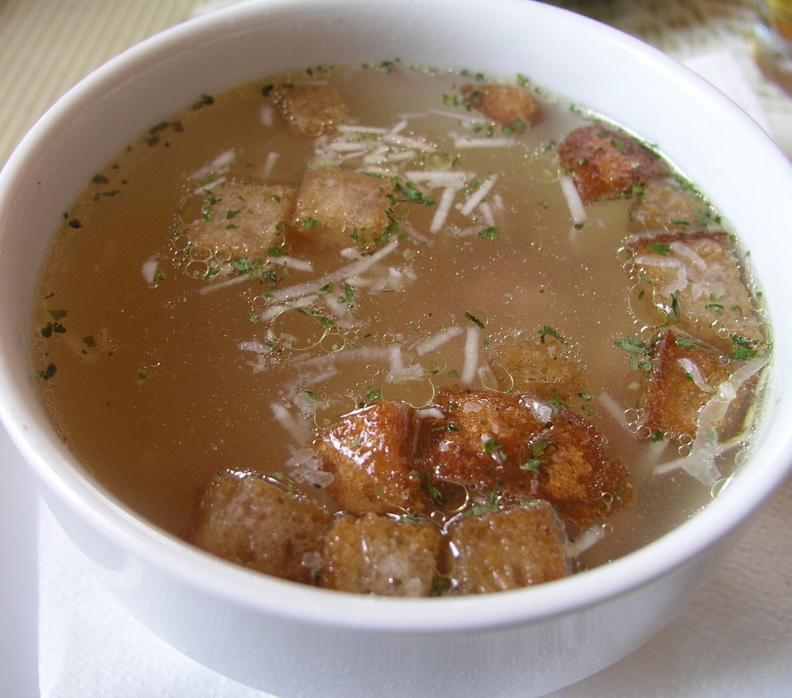 Traditional Czech garlic soup with potatoes, herbs and croutons.
