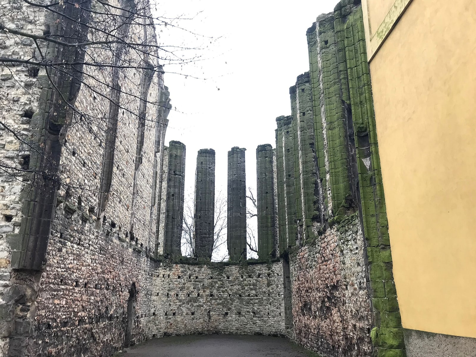 Open-to-sky interior view between the unfinished Gothic walls and columns.