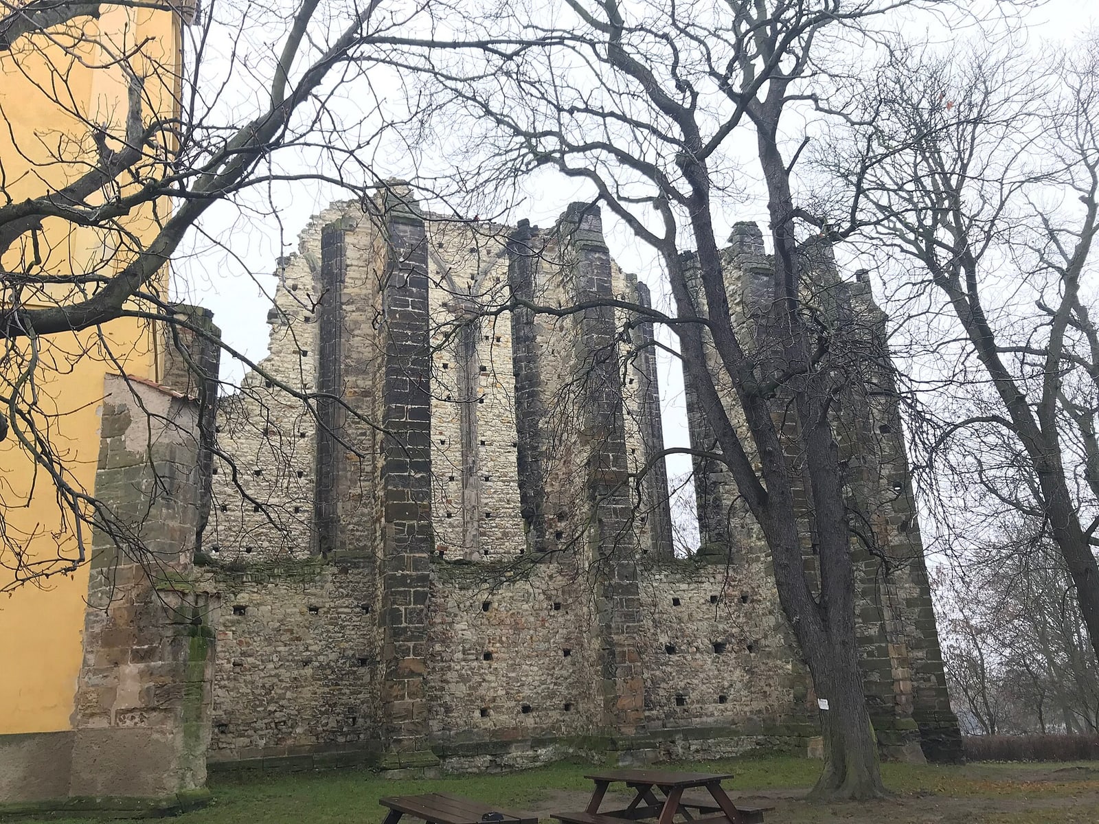 Wide overall view of the roofless unfinished church.