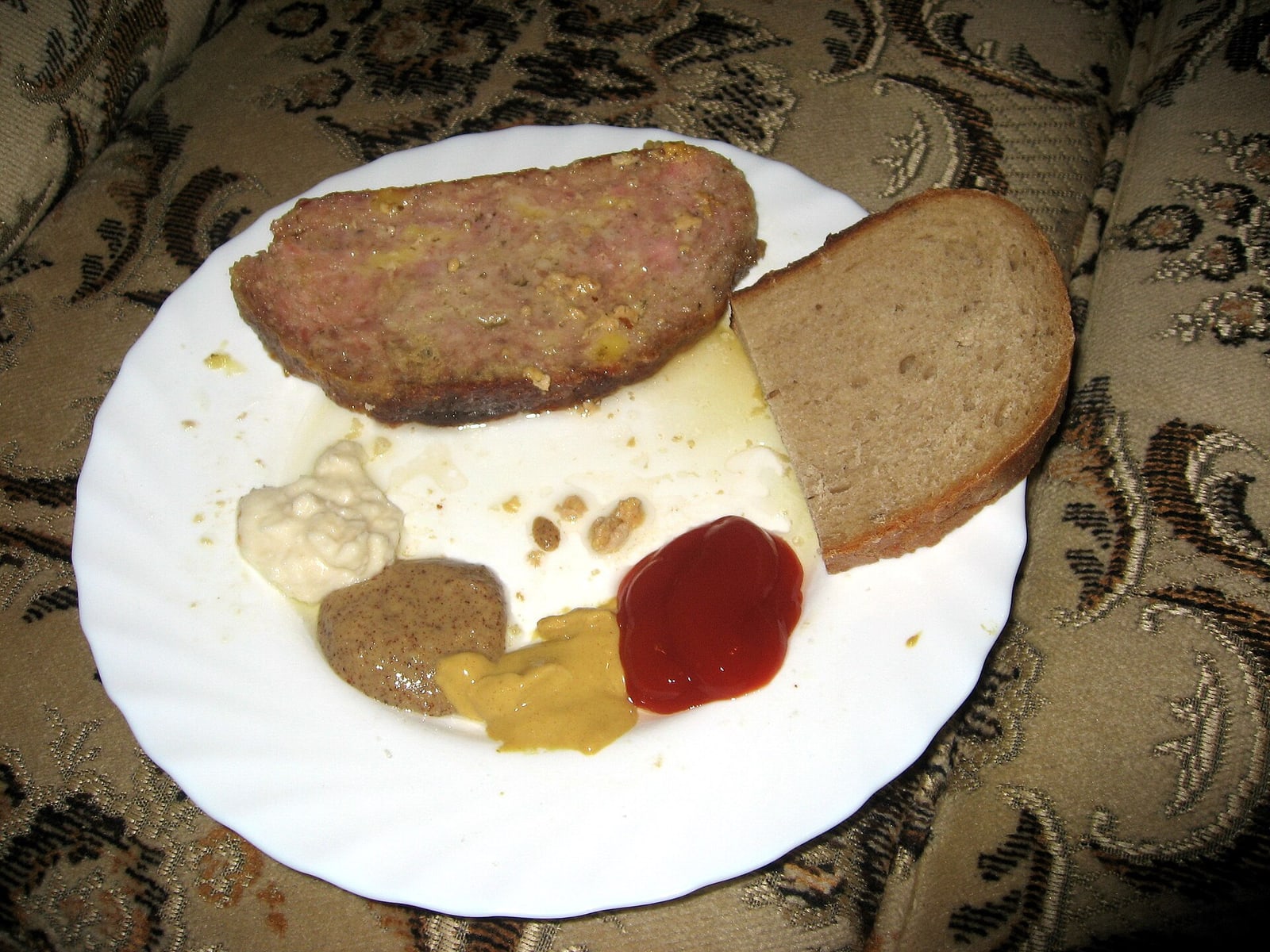 Home-style sekaná with mustard, ketchup, horseradish and bread, illustrating common accompaniments.