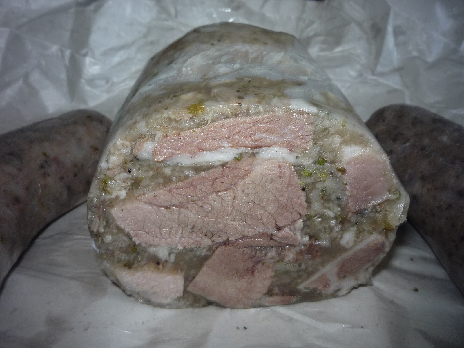 Clear sliced Czech tlačenka showing the meat-in-aspic structure.