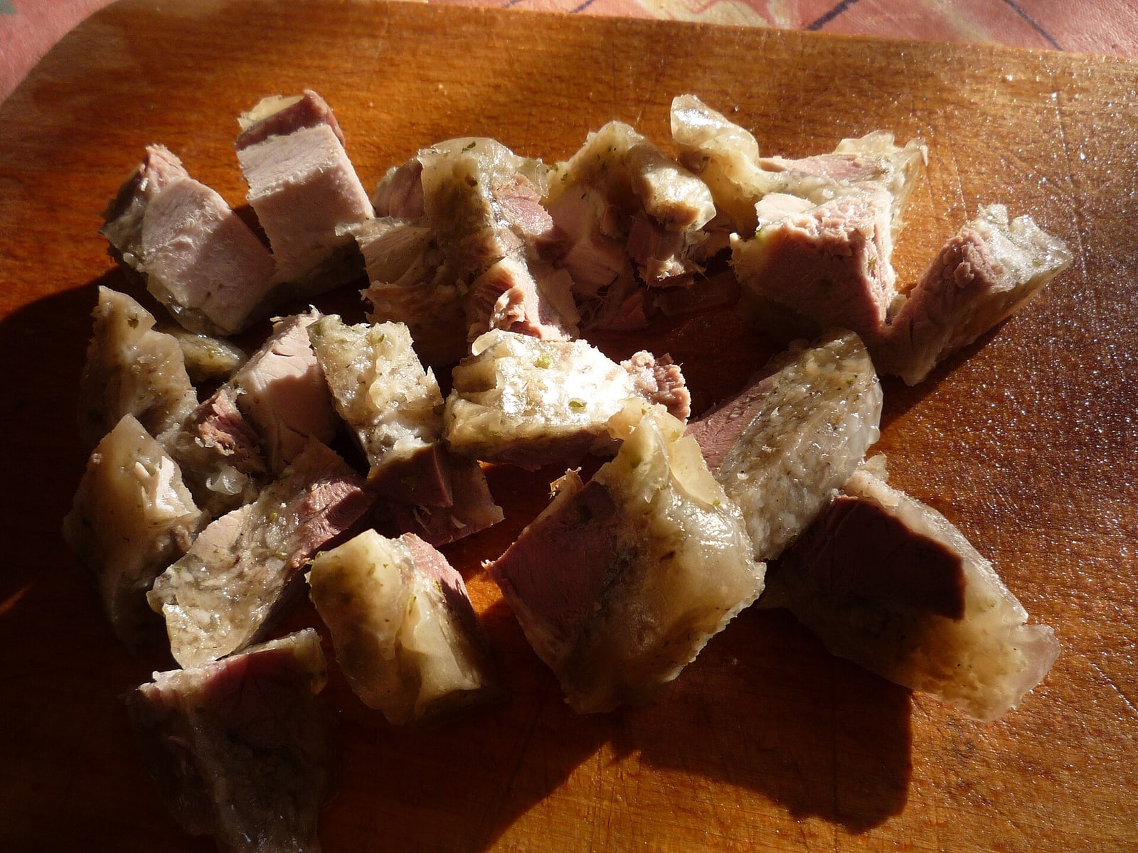 Tlačenka cut into cubes and served with vinegar, a materially different presentation.