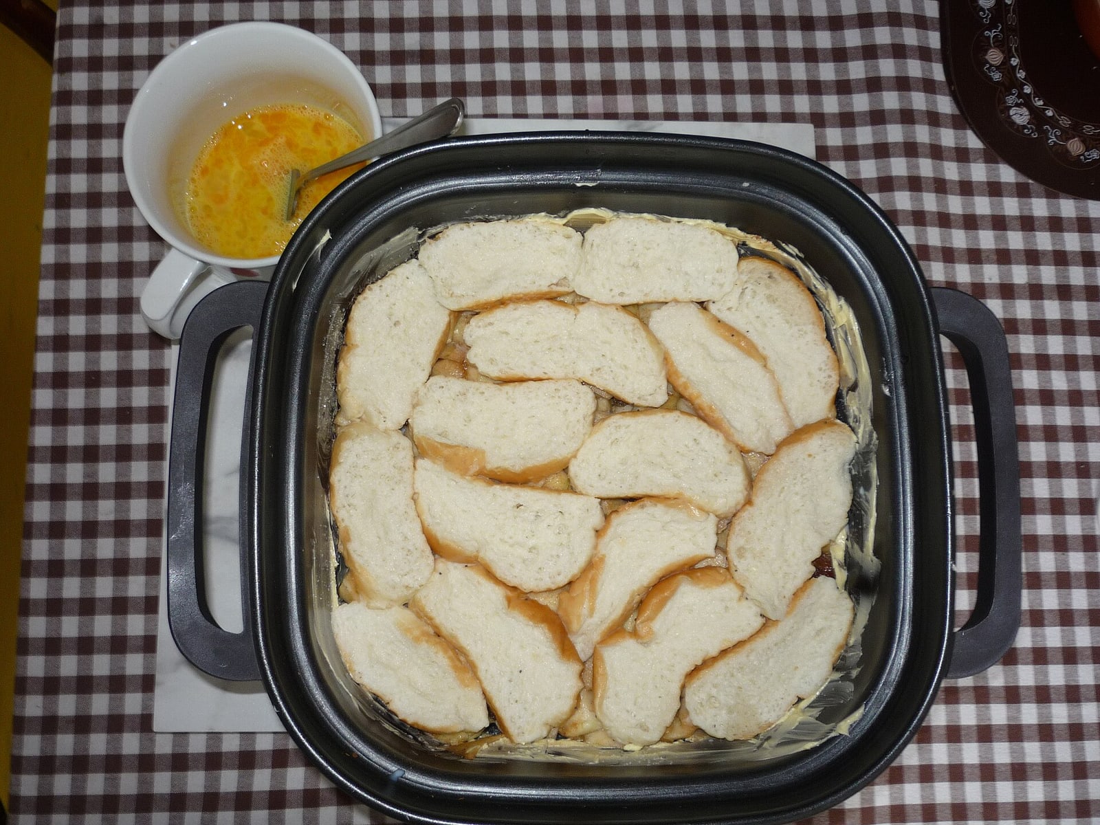 A later preparation stage, showing the custard/liquid soaking process.