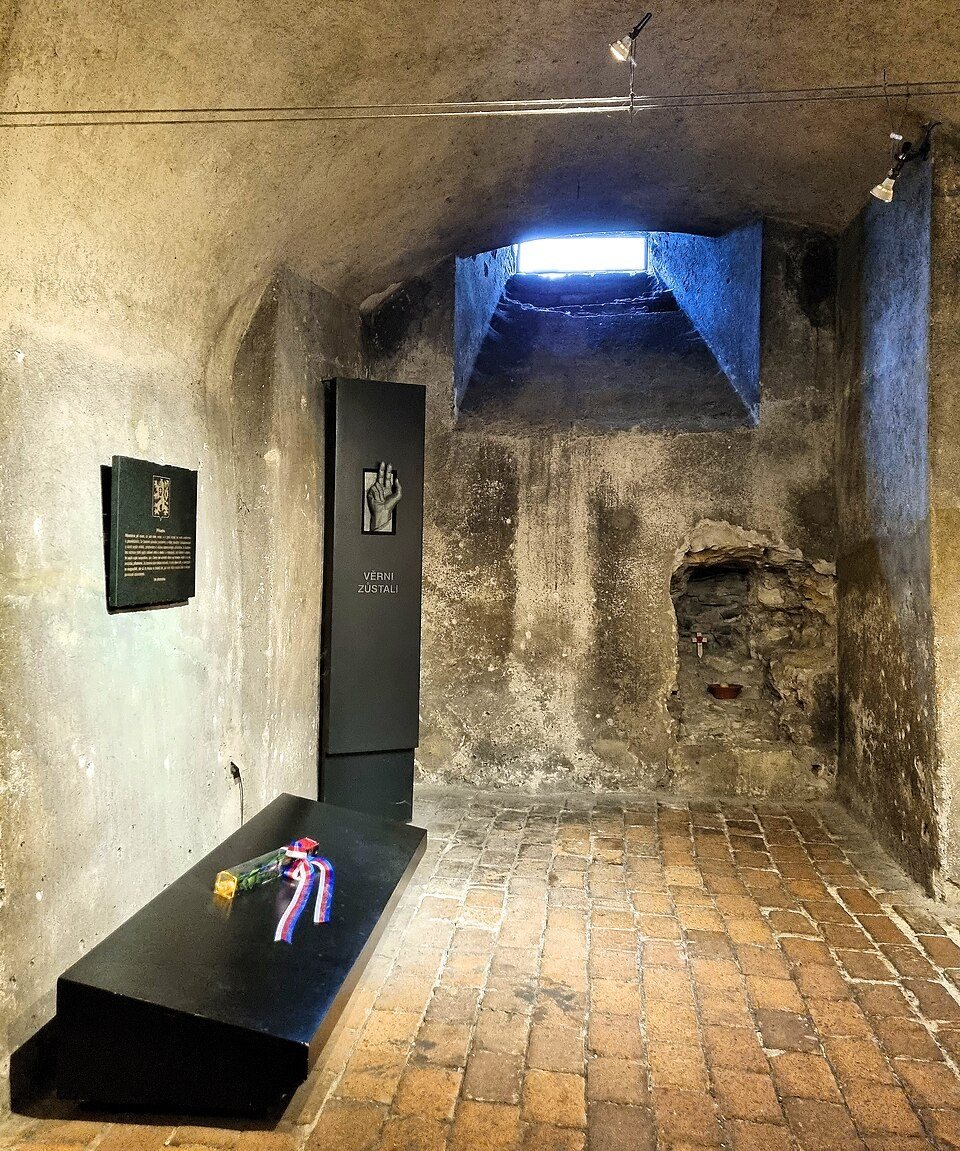 Crypt chamber with the high ventilation opening and memorial display visible.