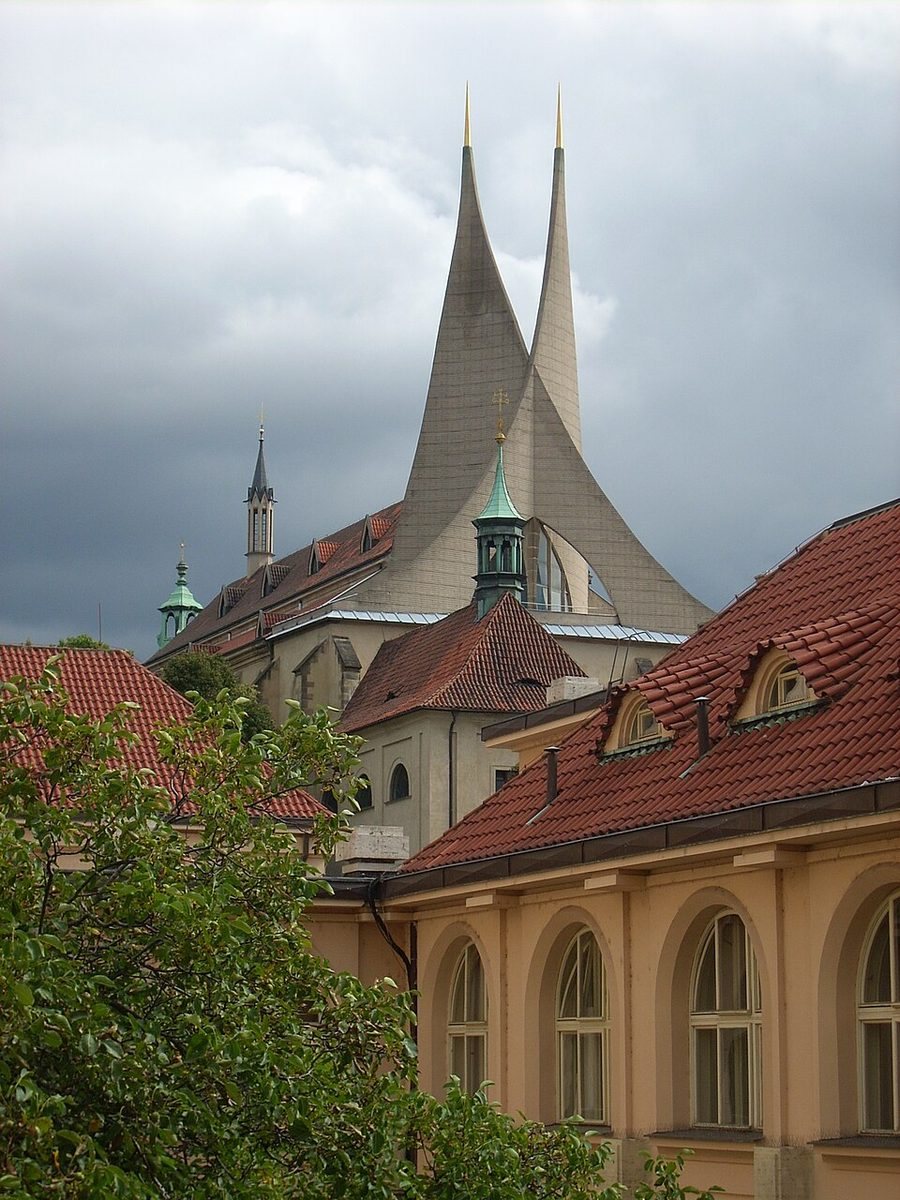 Iconic twin triangular modern towers of Emmaus Monastery clearly rising above the roofs.