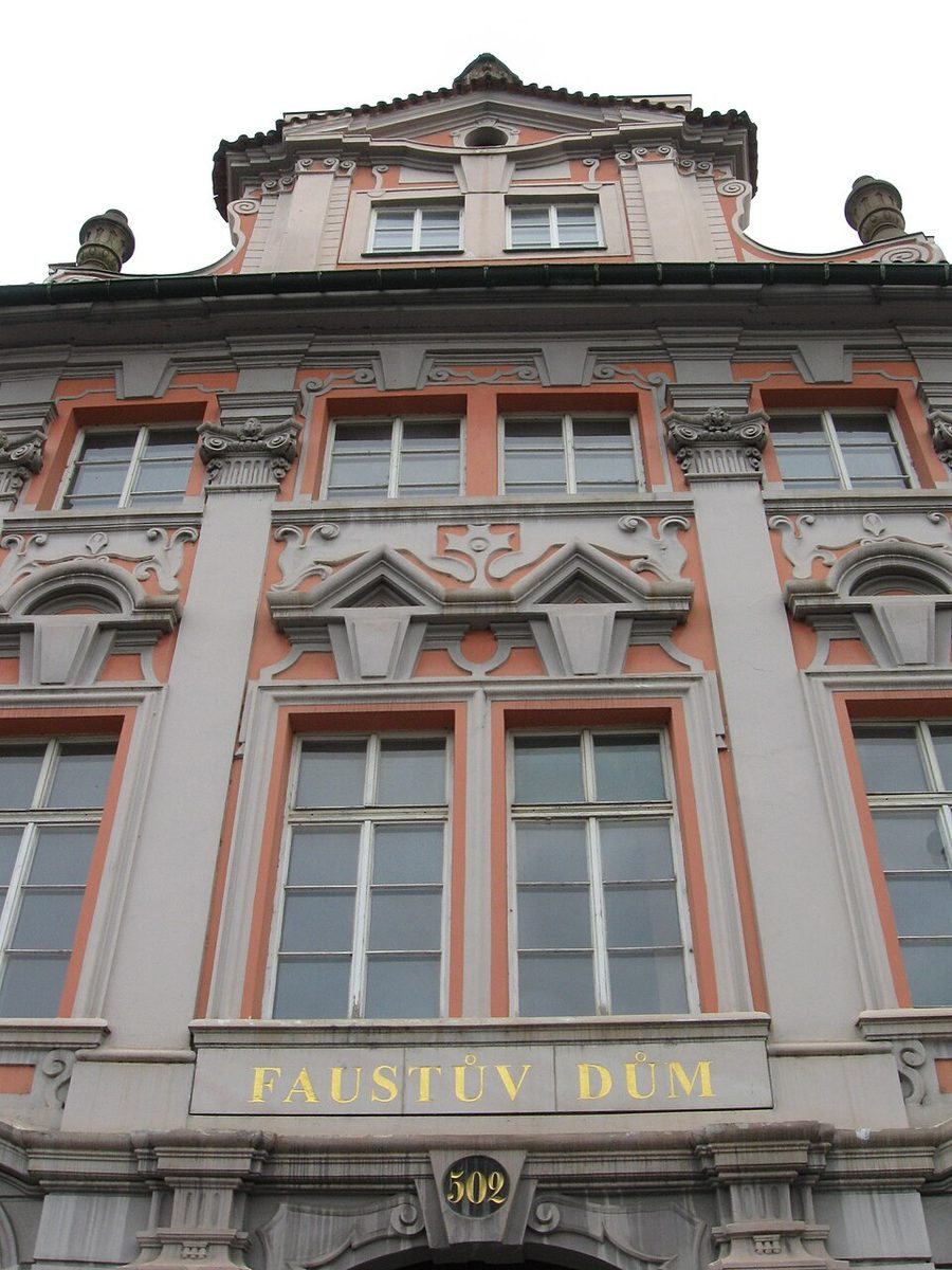 Close frontal façade with the words 'FAUSTŮV DŮM' visible above the entrance.