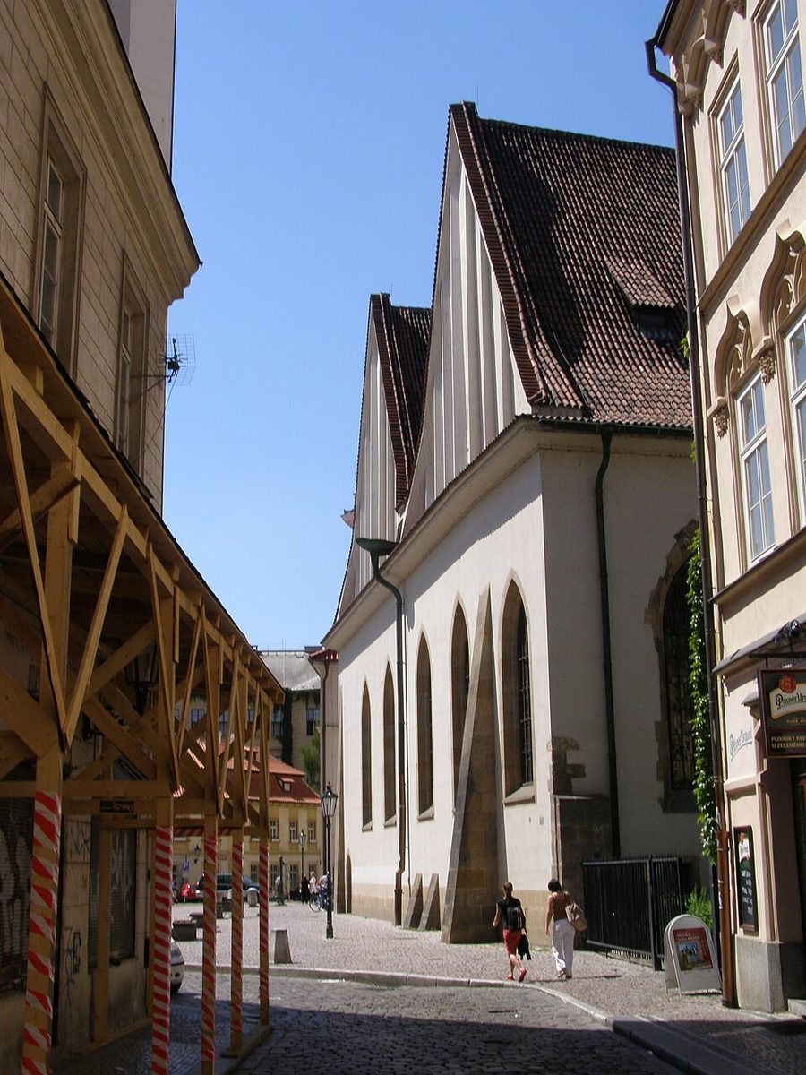 Clear street-side exterior of Bethlehem Chapel with its steep white gable and tall windows.