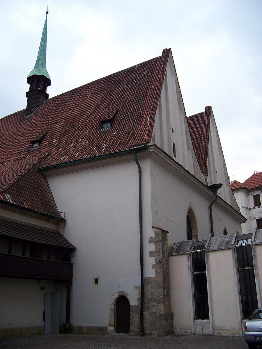 Courtyard/back-side portrait of Bethlehem Chapel with roof, walls and towerlet visible.