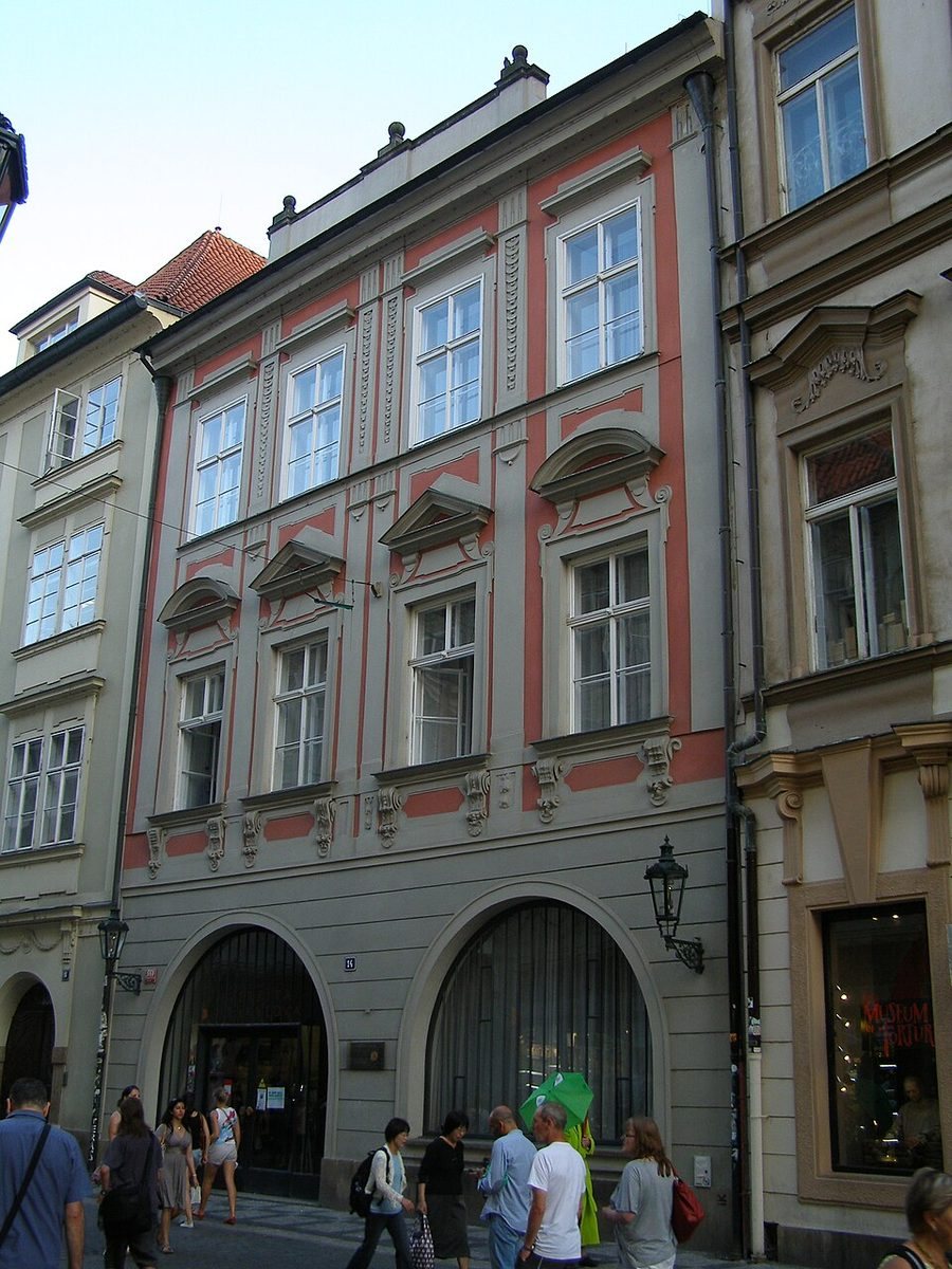 Clearer portrait of the same red-trimmed Karolinum street façade.