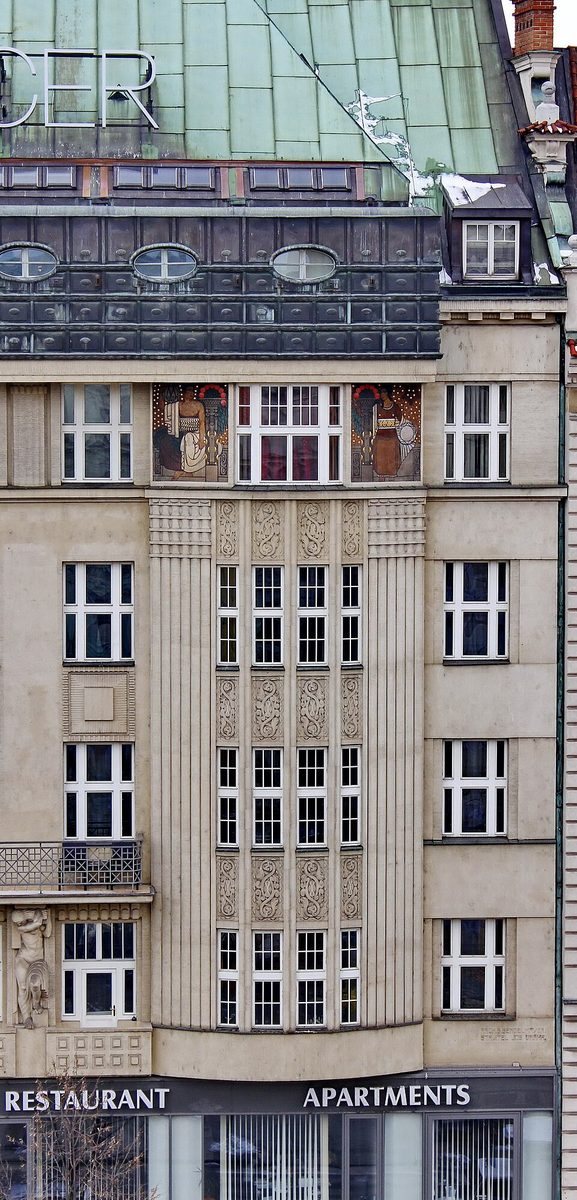 Tight portrait crop of the same façade, centered on the upper central bays and balcony area.