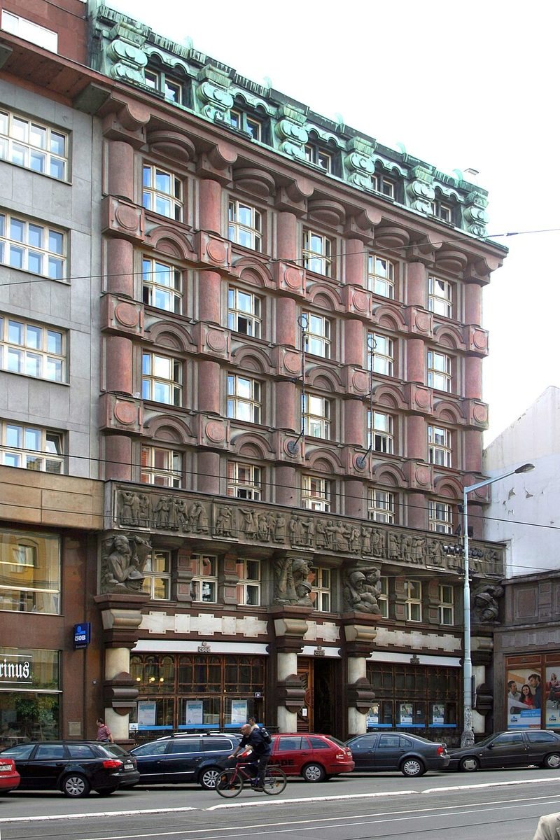 Tall three-quarter view of the same distinctive rounded-and-blocky façade.