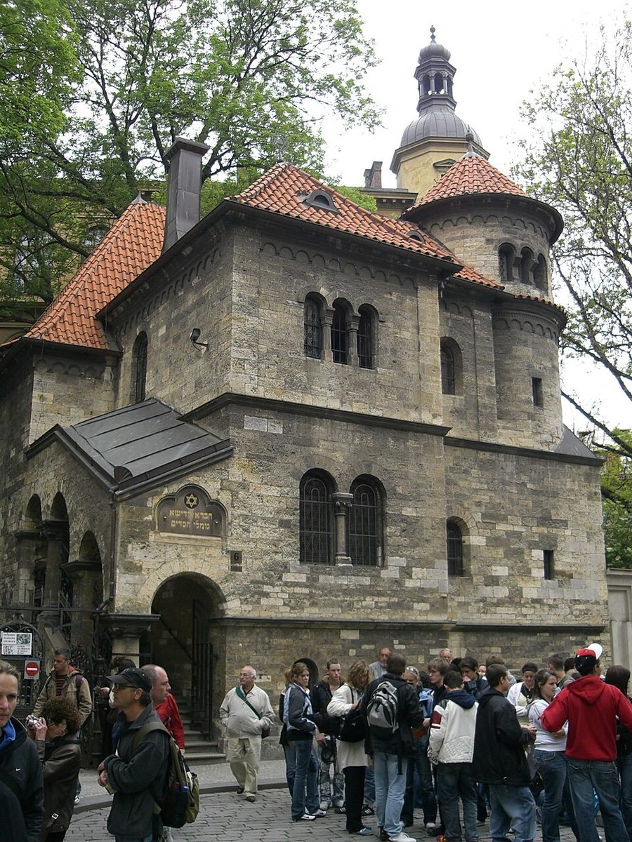 Recognizable Romanesque-revival Ceremonial Hall/Jewish Museum site with visitors outside.