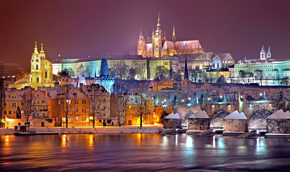 Approved illuminated Prague night scene used as generic electric-light context; exact fountain is not asserted visually.