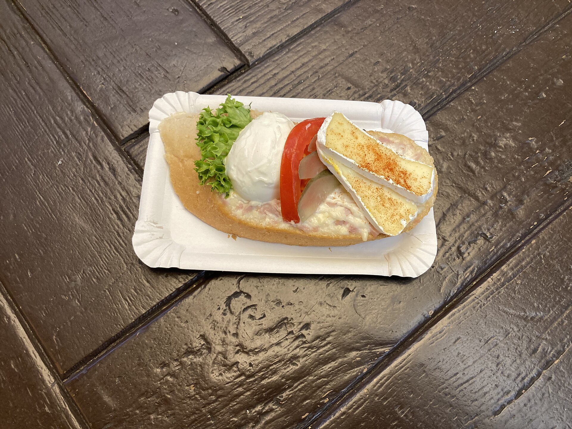 A Czech chlebíček served open-faced with cheese and egg toppings.