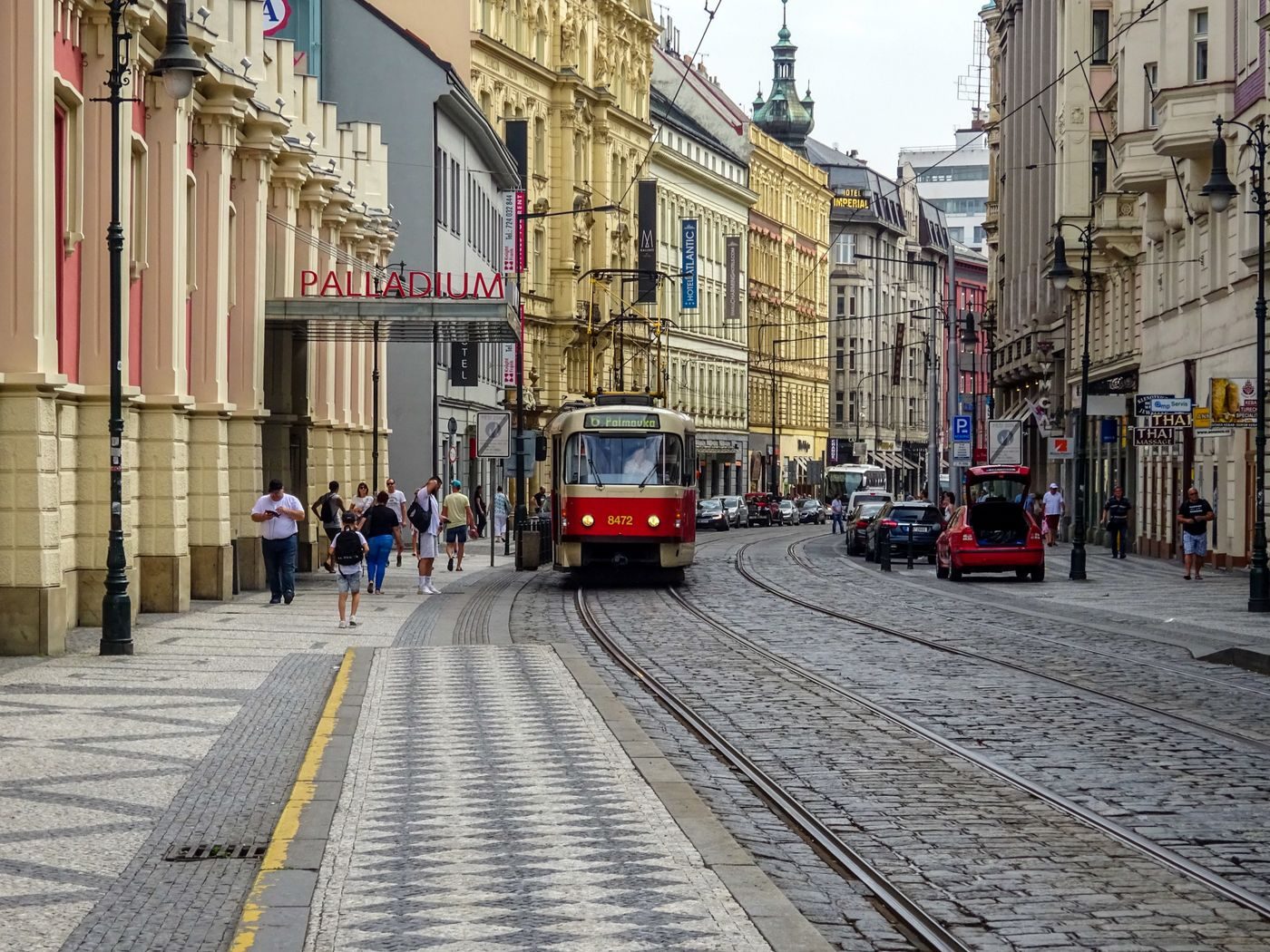 Prague pedestrians and public transport visibly create city context.