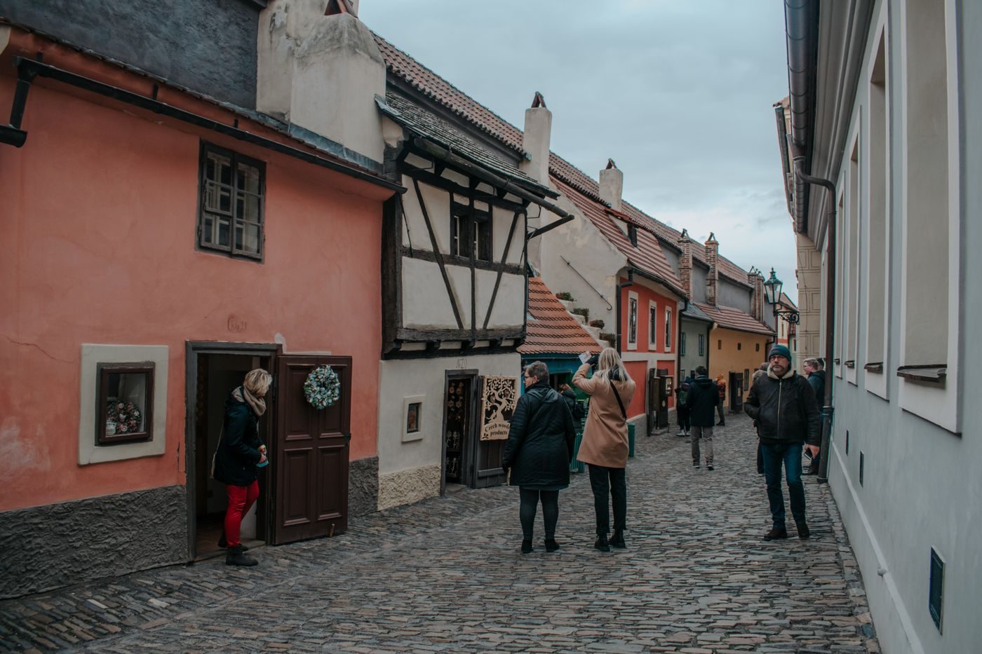 Visual/page inspection confirms Golden Lane with tiny colorful houses and tourists in the constrained cobbled street.