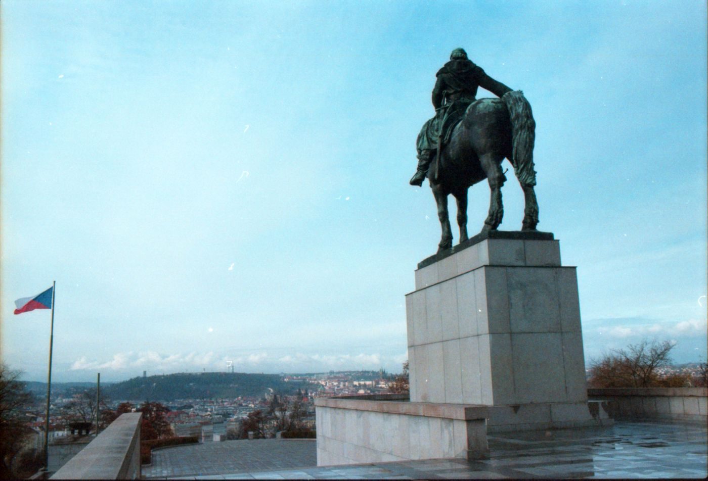 Exact Jan Žižka equestrian statue is visibly foregrounded on Vítkov with Prague spread below.