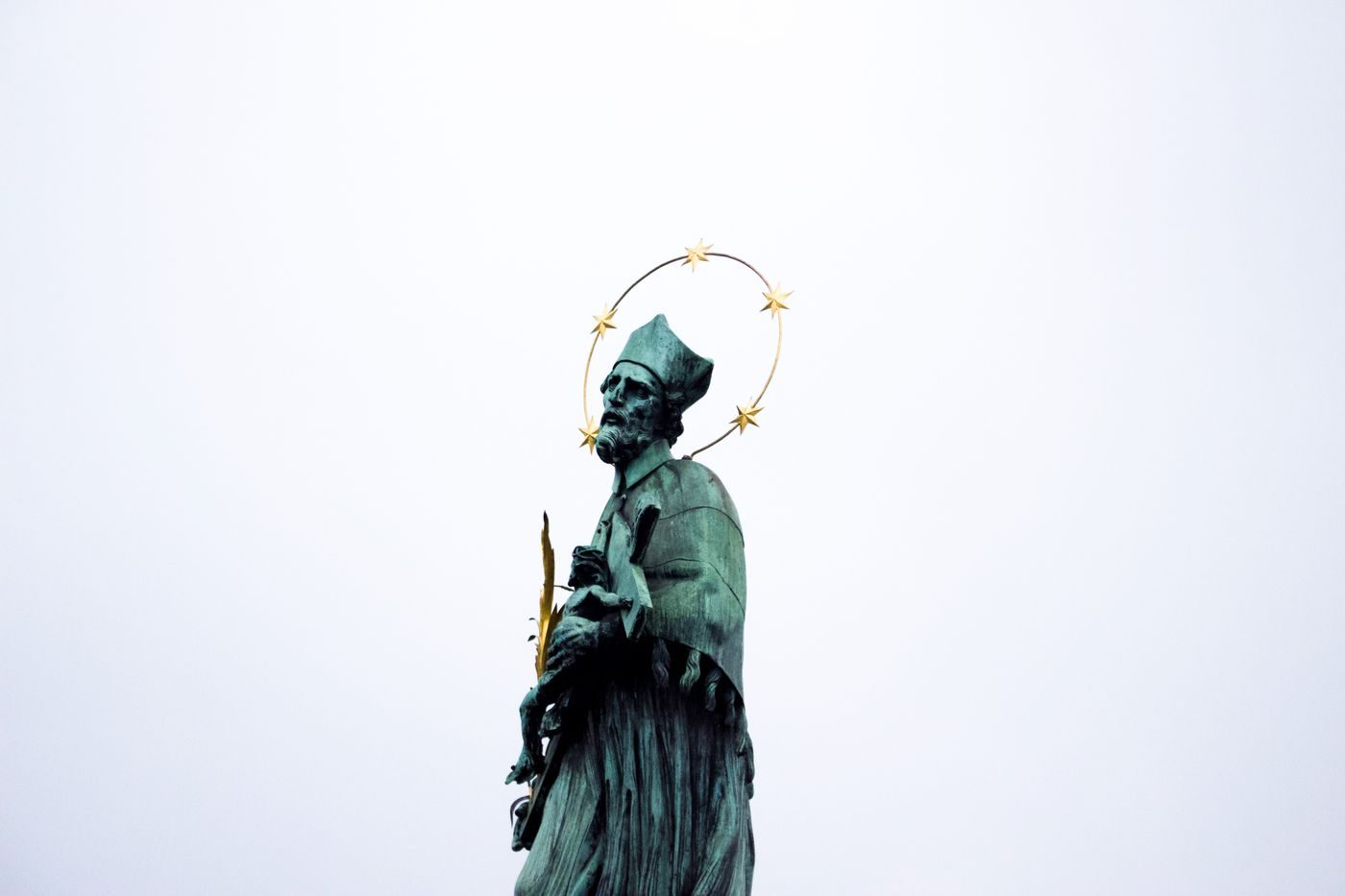 A different exact Charles Bridge statue is visibly isolated.