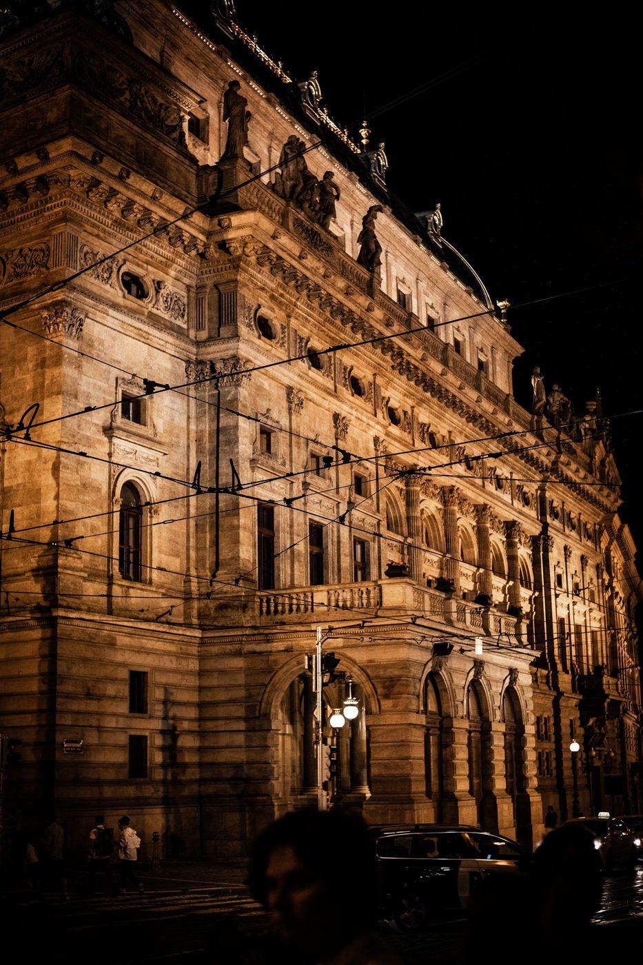 Exact illuminated National Theatre façade is visibly shown with architectural detail.