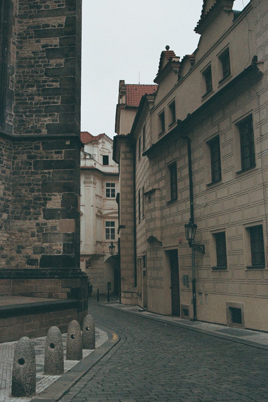 Prague pedestrian paving and historic street frontage are visibly shown.
