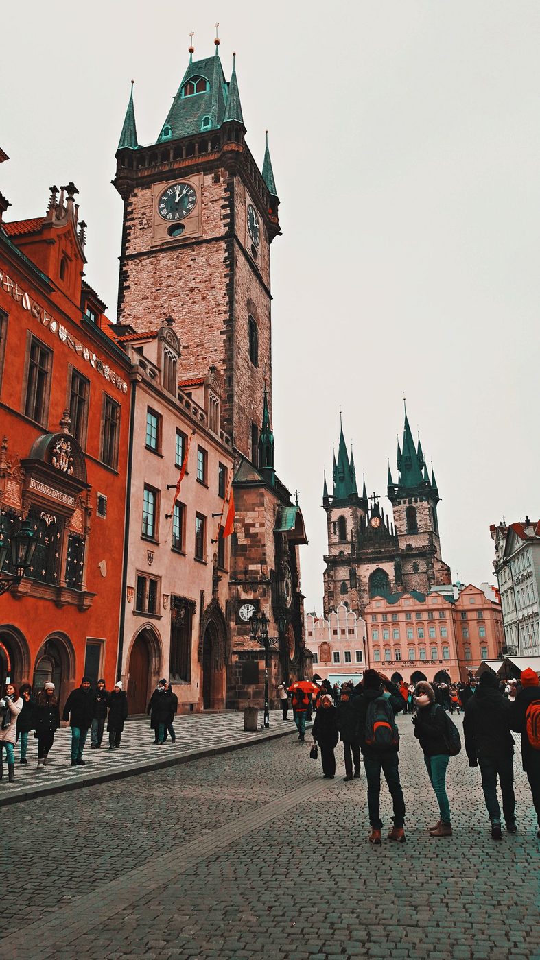 Old Town Square with Týn Church and crowds is visibly shown in Prague.