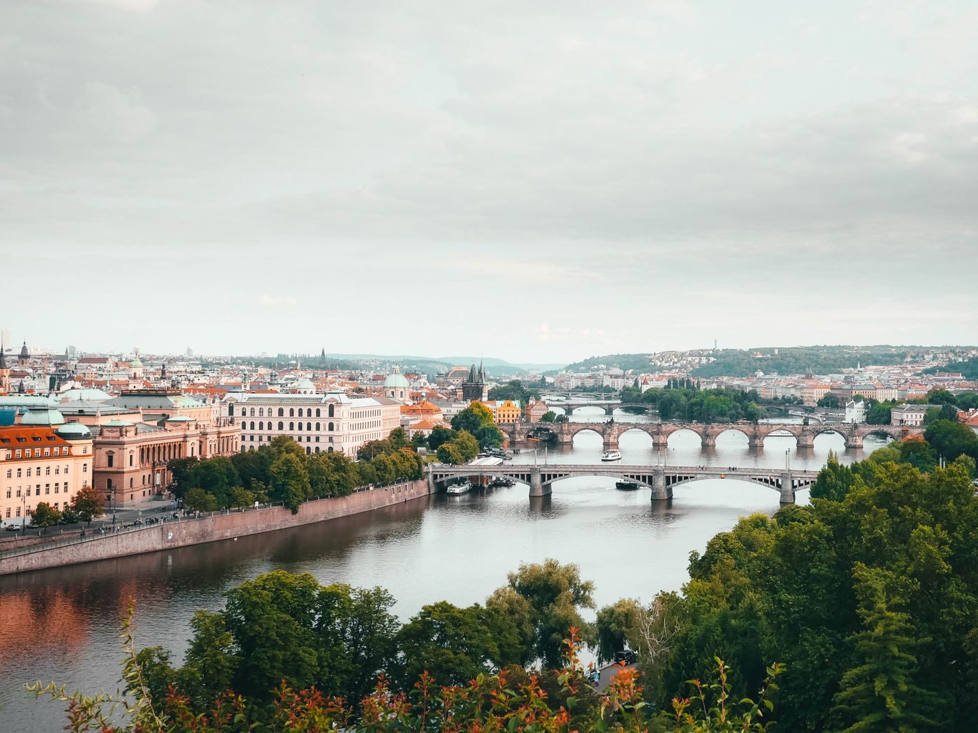 Aerial Prague/Vltava corridor with multiple bridges is visibly shown.
