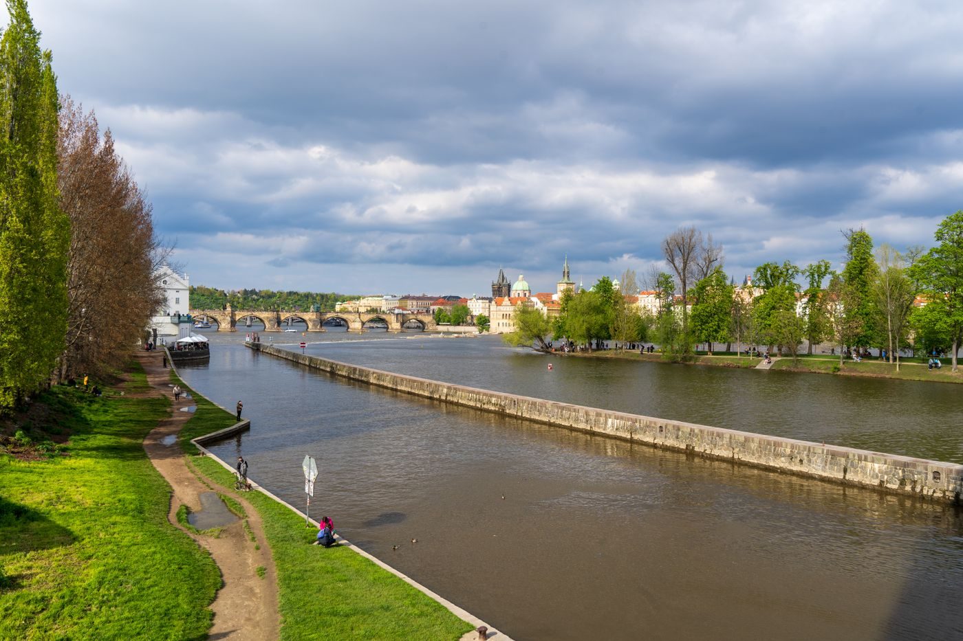 Exact Charles Bridge/Vltava geography is visibly established.
