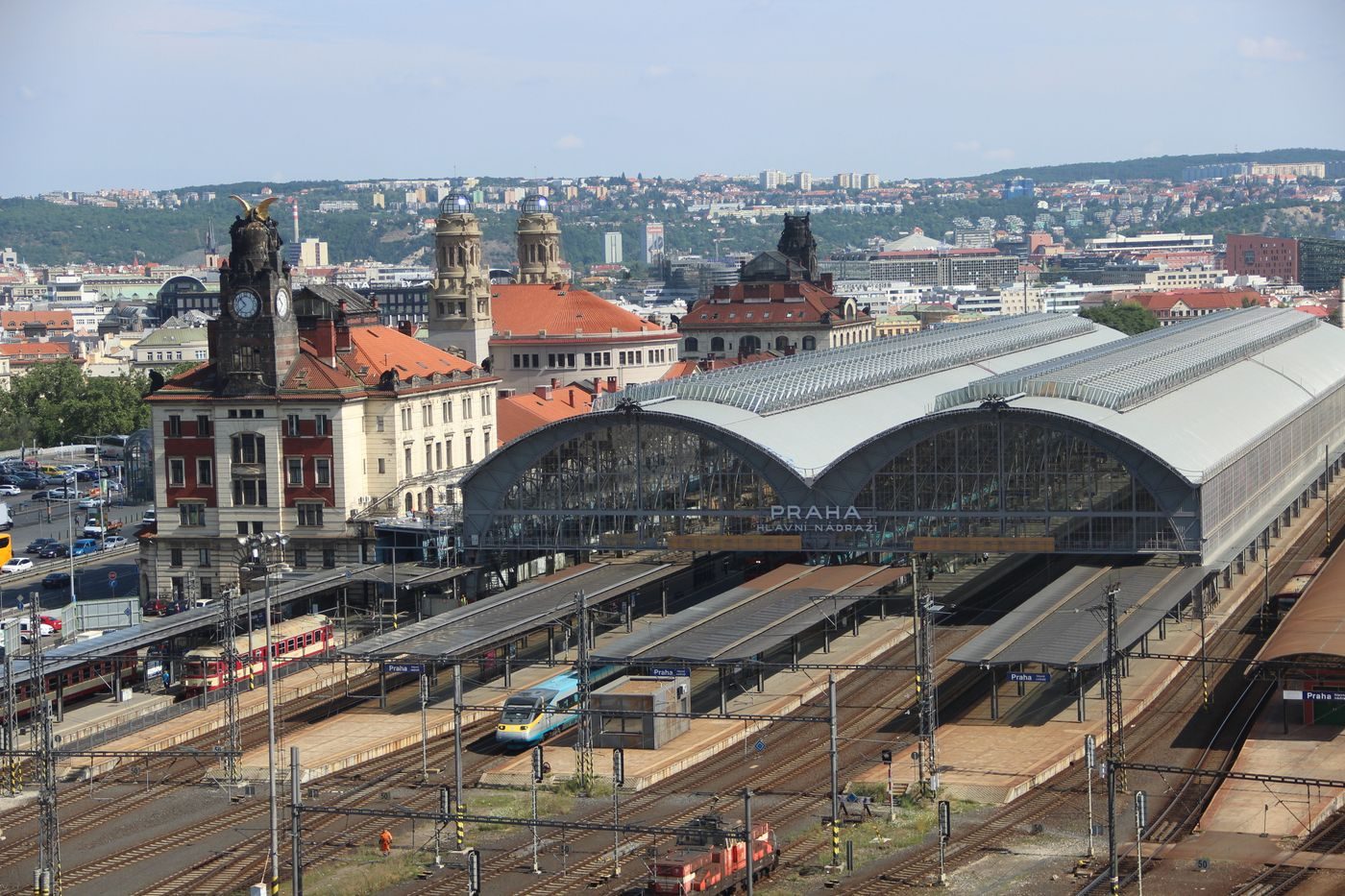 High-angle exact Prague Main Station view visibly shows station envelope and urban transport scale.