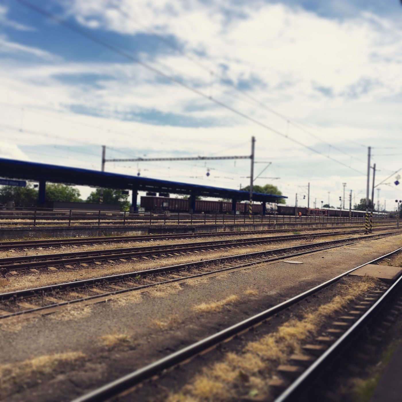 Railway tracks and station infrastructure are visibly present; exact Prague station identity is not established.