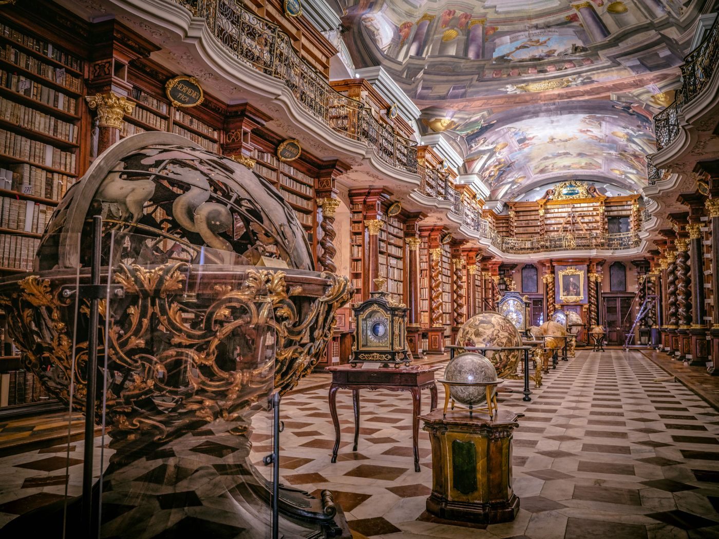 Historic Klementinum-indexed library with celestial globes is visibly shown.