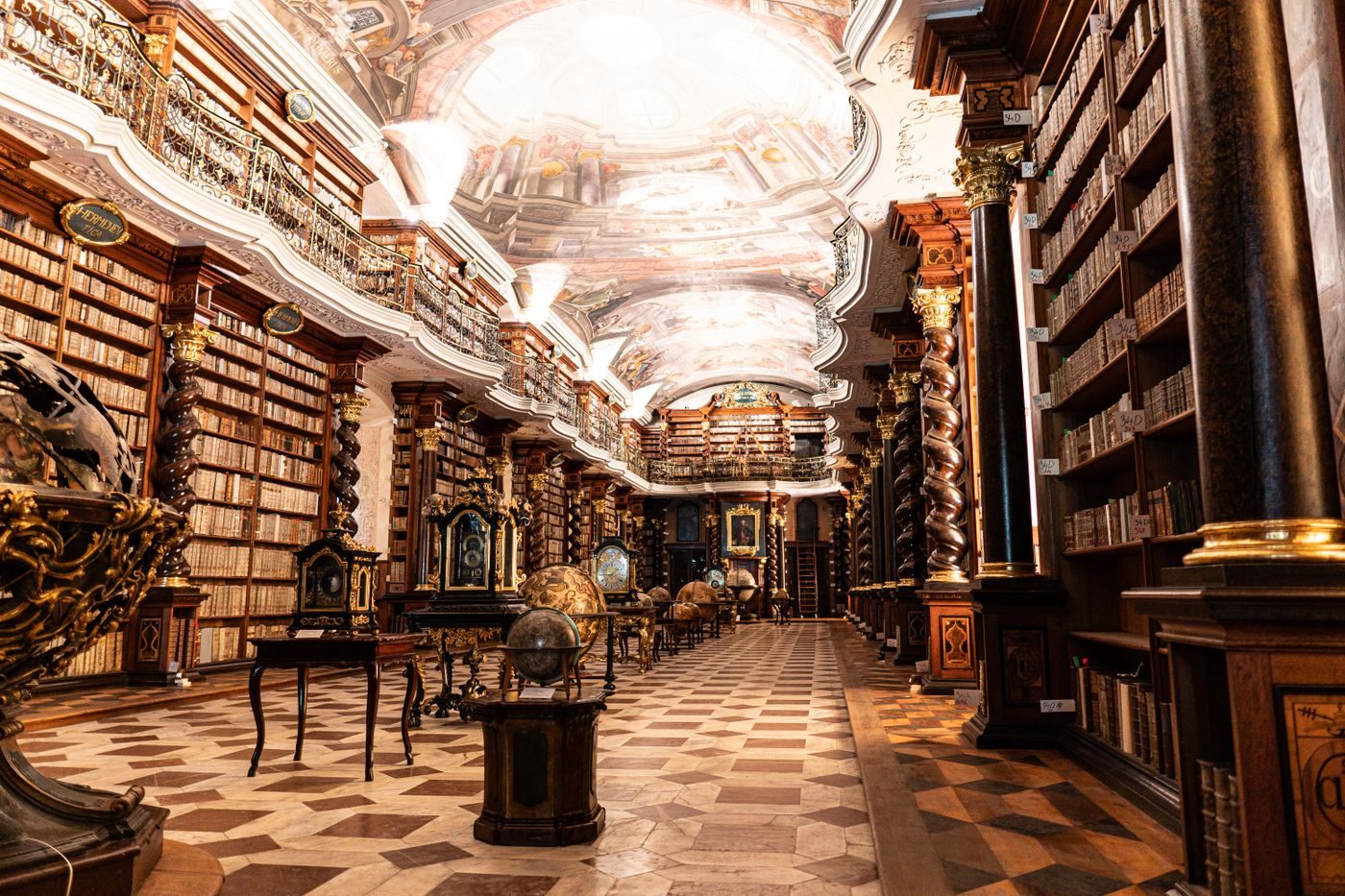 Exact Klementinum Library interior visibly establishes the scientific/historic institution.
