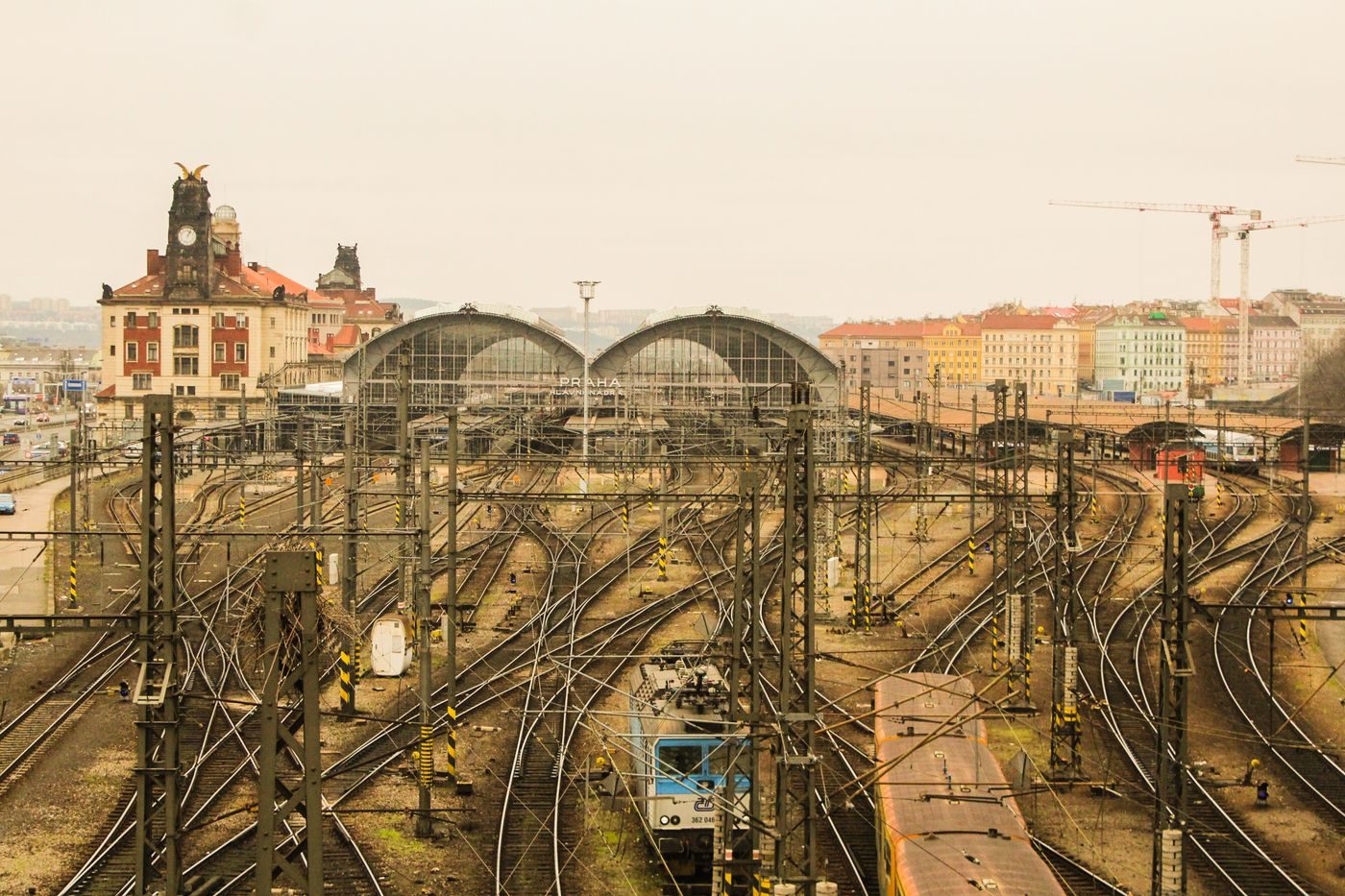 Exact Prague Main Station tracks and historic station architecture are visibly shown.