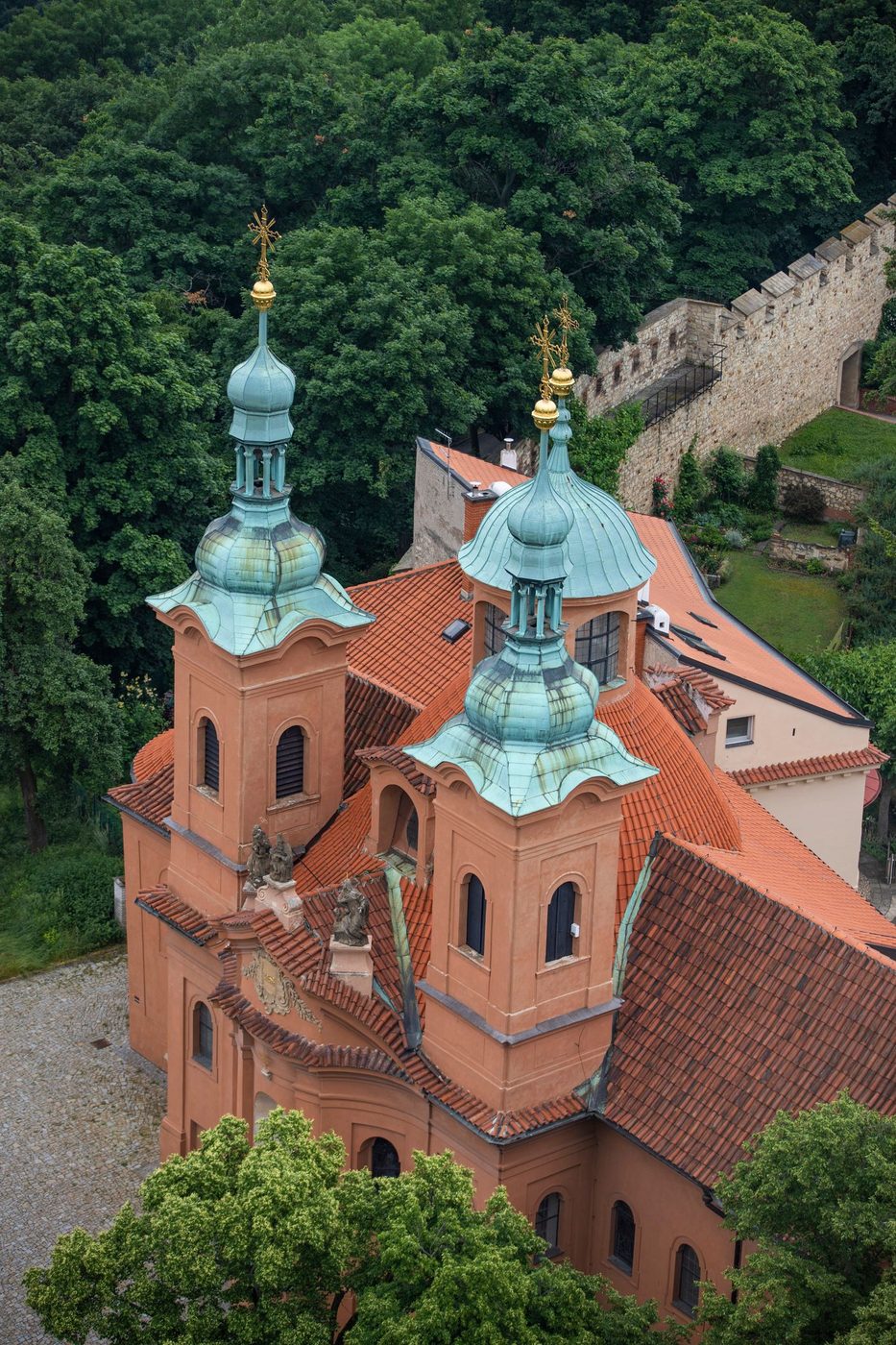 An exact Petřín Hill landmark and green hillside context are visibly shown above central Prague.